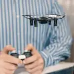 man piloting drone indoors