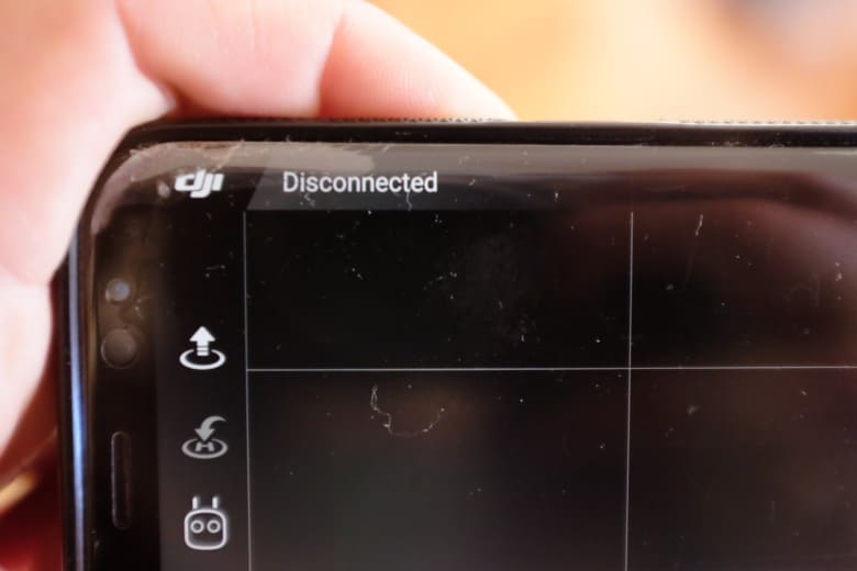 Me holding smartphone - DJI GO app disconnected